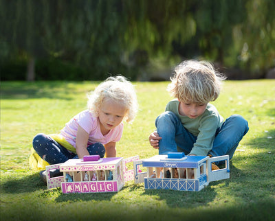 Two children playing with Breyer Carry Stables