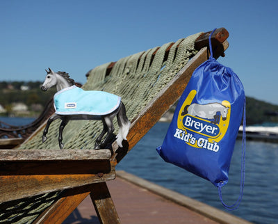 Breyer Kid’s Club Deluxe Membership - Model and backpack with a lake in the background