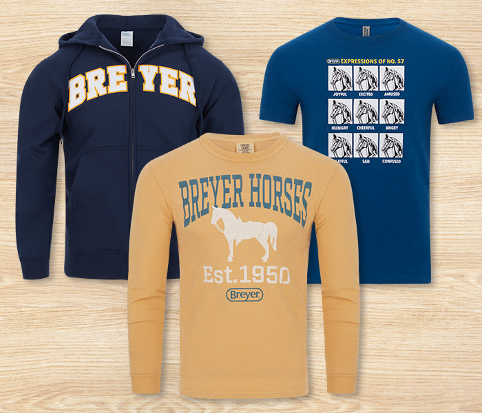 Breyer Apparel featuring T-Shirts and a Hoodie on a wood background