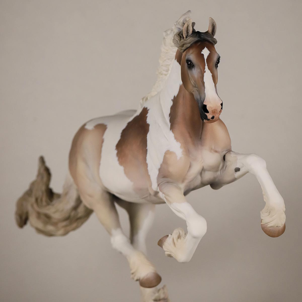 A Breyer Premier Club Model on a taupe background