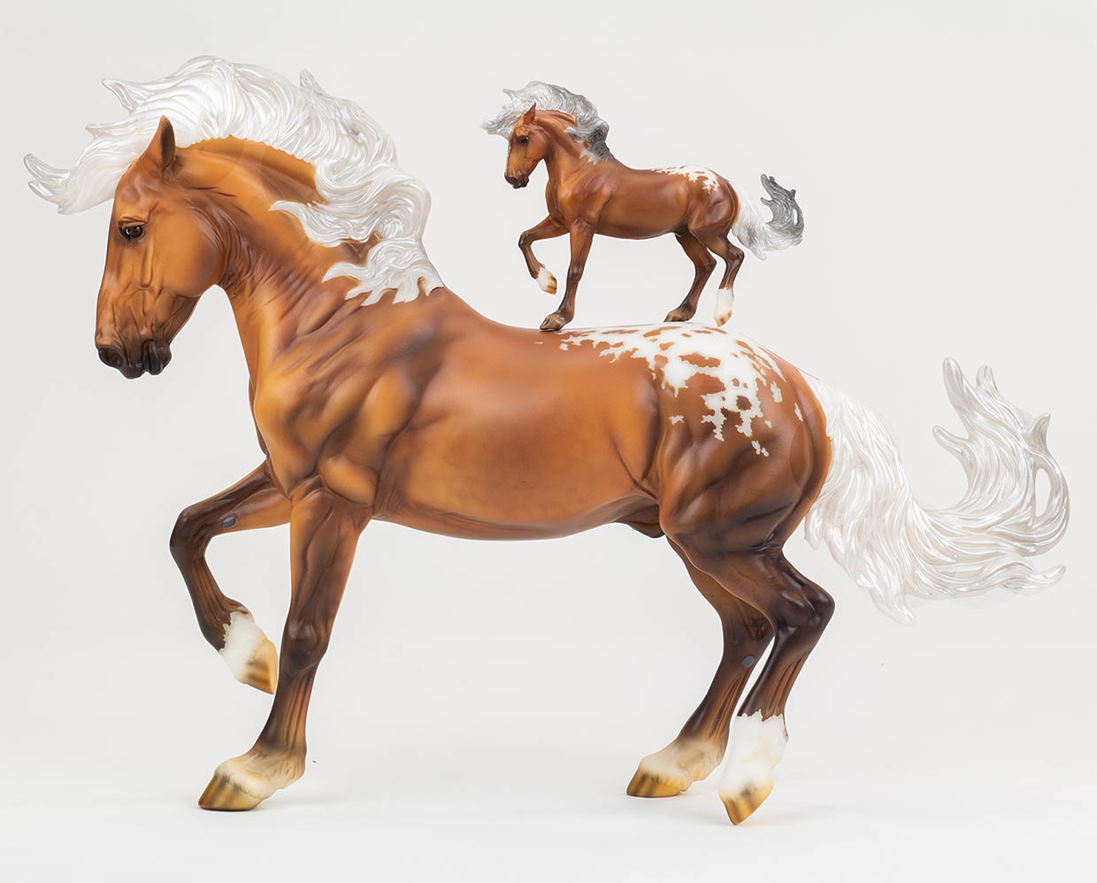 A Premier Club Bonus Stablemate riding on a Traditional Scale Breyer Model