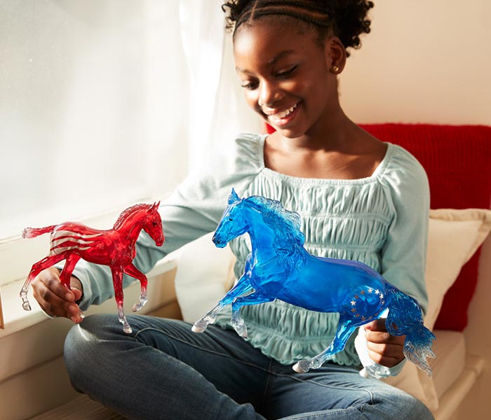 A girl playing with the Betsy & Ross Model set - The 250th Anniversary Collection