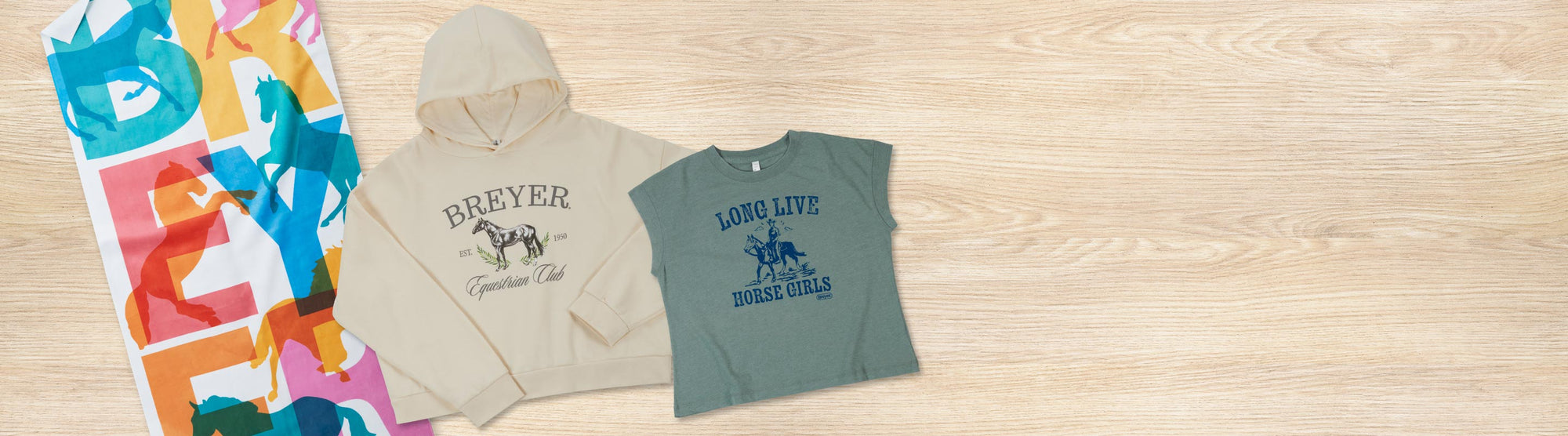 Breyer Gifts featuring hoodies, shirts and a towel on a wood background