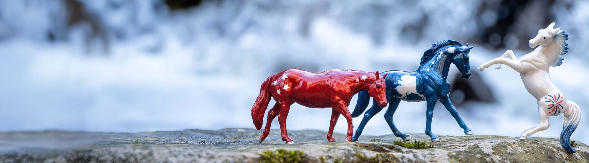 Americana Sale - Featuring the Pursuit of Happiness Set on a rock in front of a waterfall.