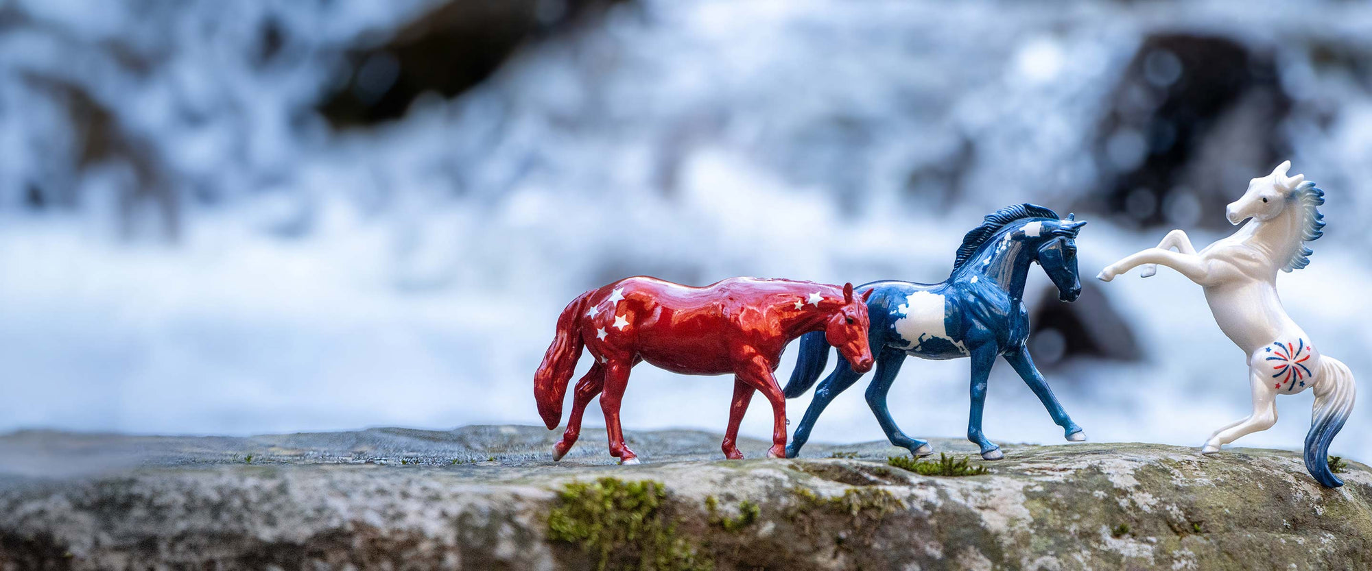 Americana Sale - Featuring the Pursuit of Happiness Set on a rock in front of a waterfall.