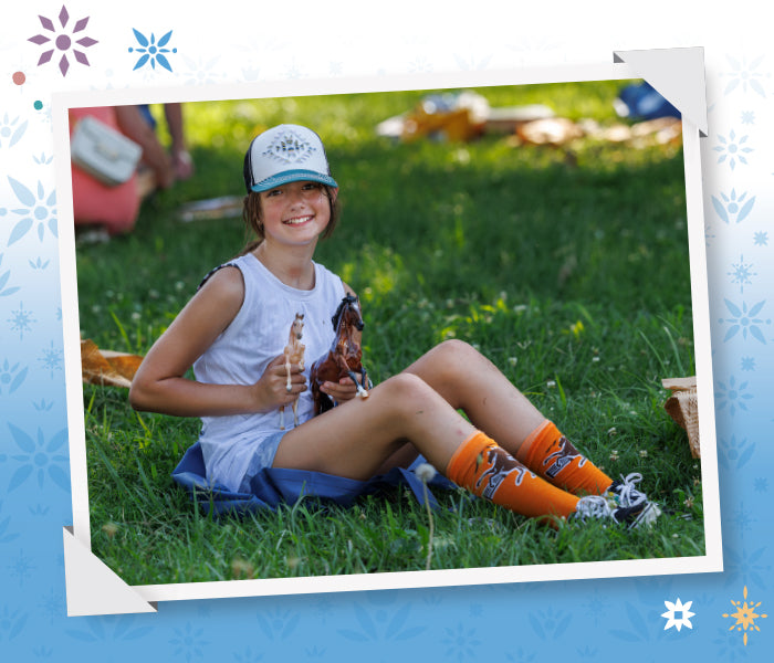 BreyerFest Tickets Are On Sale Featuring an attendee at BreyerFest holding Breyer Models.