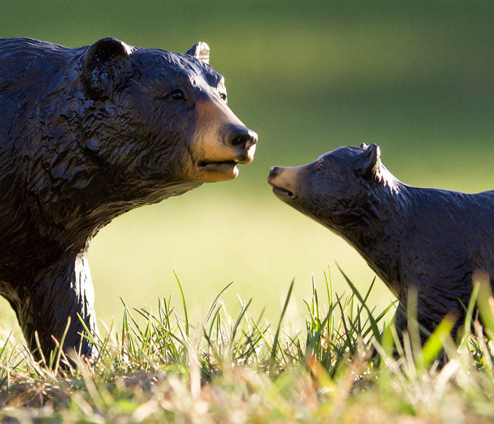  Black Bear & Cub Breyer Models walking in a field of grass.