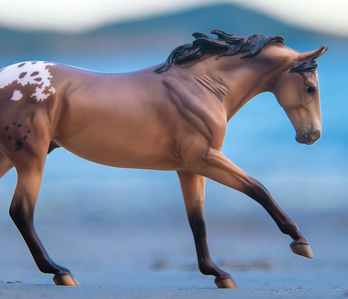 Mr. Shining Gun Breyer Model standing in a ranch setting