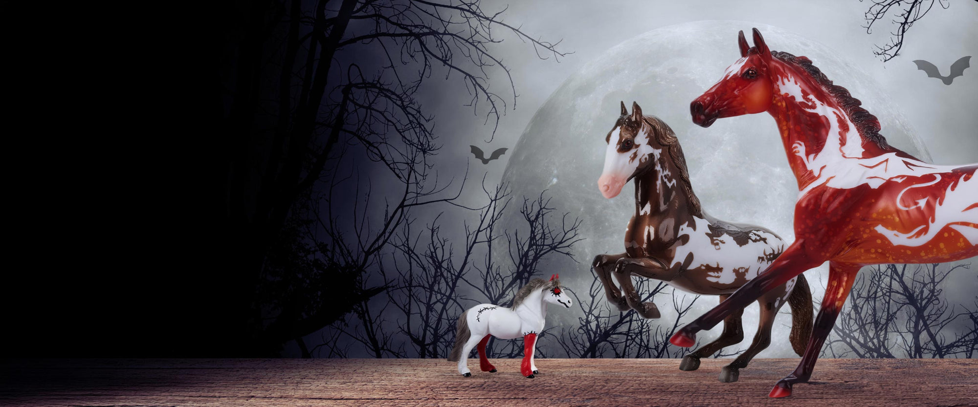 The 2026 Halloween Collection models on a creepy background with a giant moon in the background