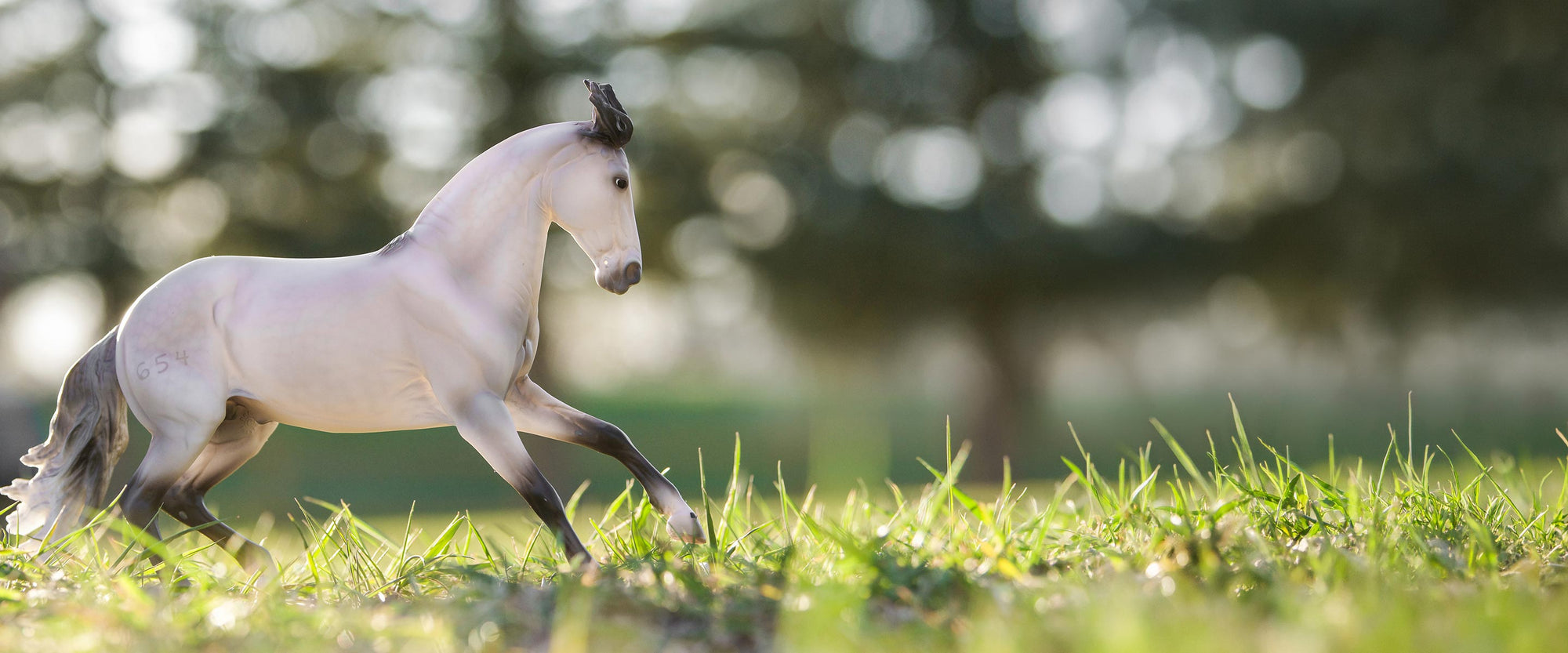 Labor Day Sale - Featuring Breyer's Jaguel Hilton model standing outside in grass
