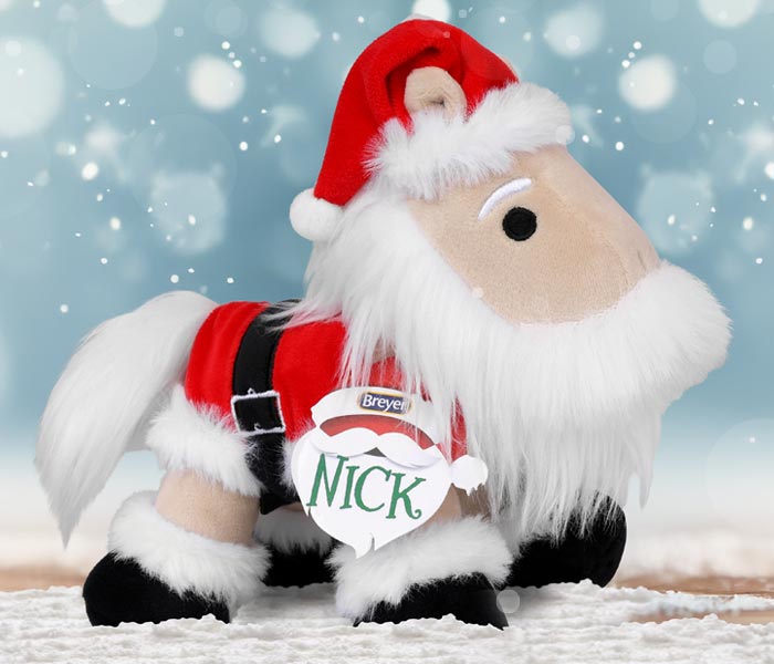 Nick - The 2025 Holiday Plush in a snowy setting.