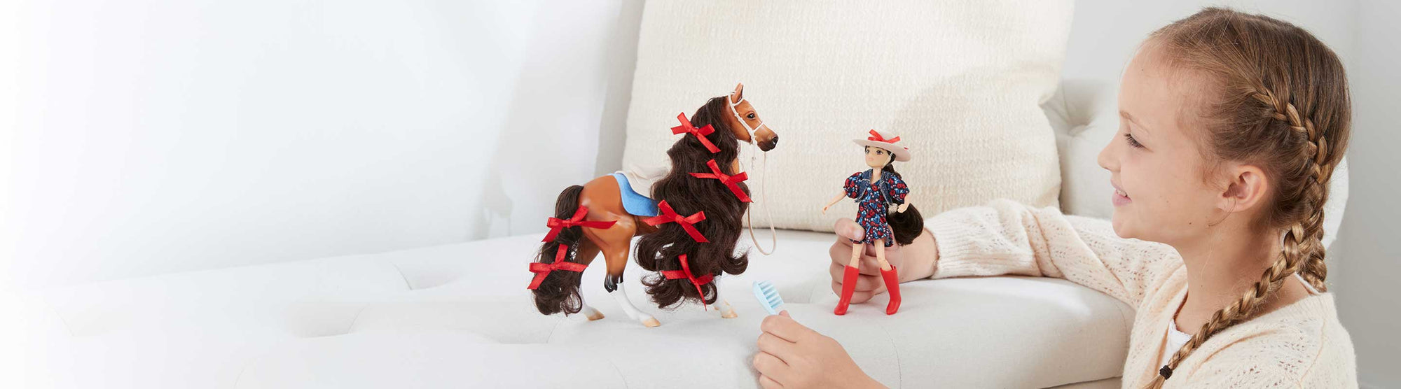 The Freedom Series Collection - a child playing with models on a couch