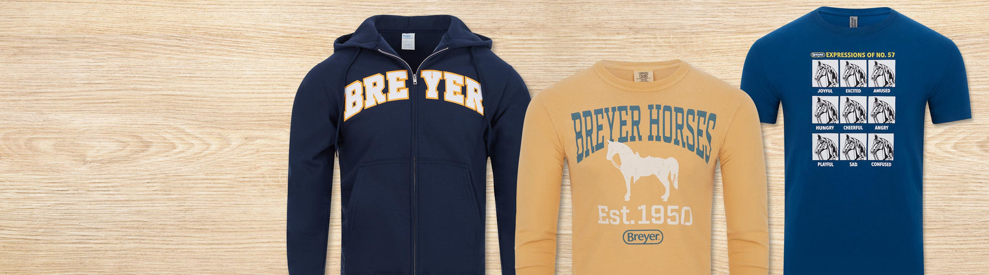 Breyer Apparel featuring T-Shirts and a Hoodie on a wood background