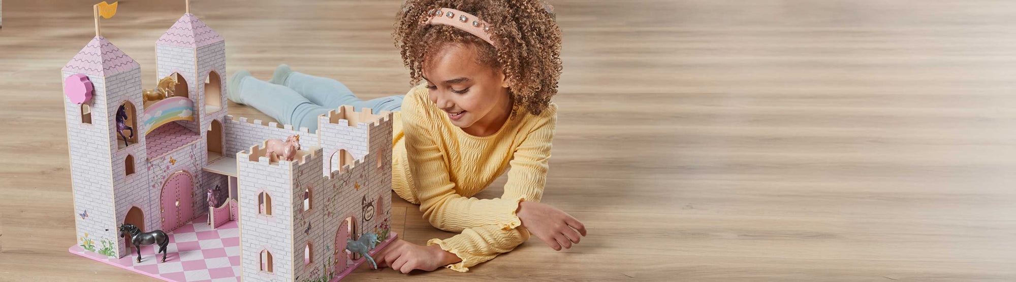 The Stablemates Collection - a child playing with the Stablemates Castle
