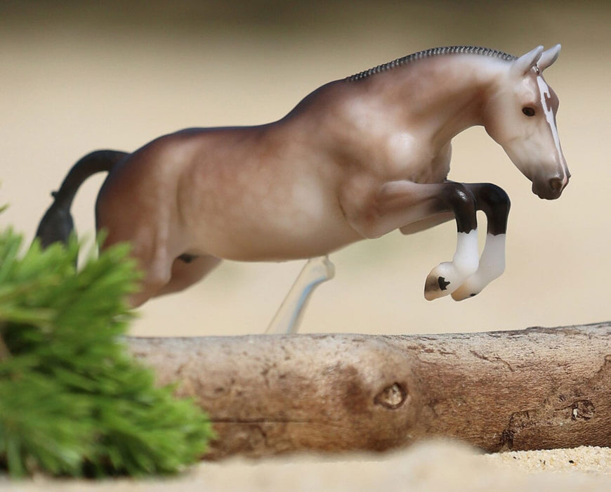 Luca - A 2027 Stablemates Club release shown jumping over a log