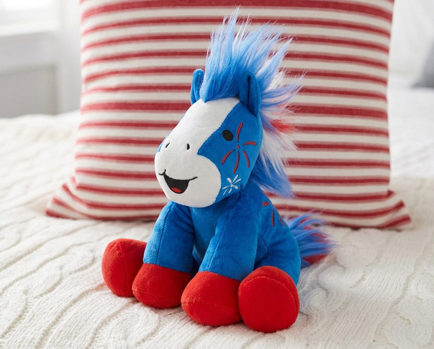 Boom | 2026 Americana Plush - facing right on a bed