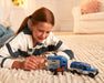 A child playing with the Breyer Farms™ Land Rover® and Tag-A-Long Horse Trailer on the floor
