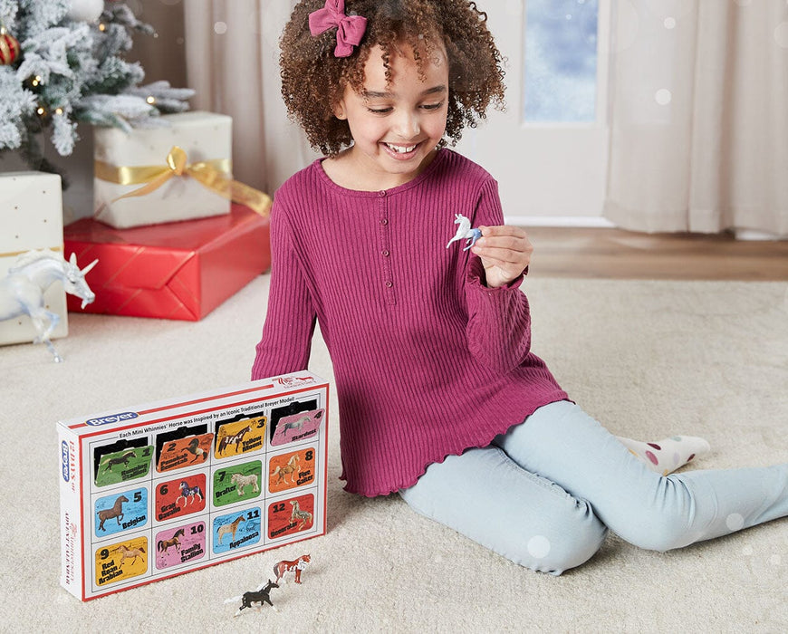 A child playing with the Breyer's 75th Anniversary Edition Advent Calendar