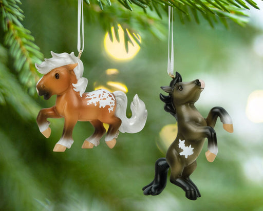 Fireheart & Mauvelous | 2026 Mini Ornament Set hanging from a tree