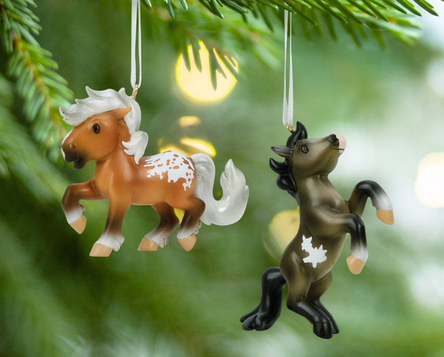 Fireheart & Mauvelous | 2026 Mini Ornament Set hanging from a tree