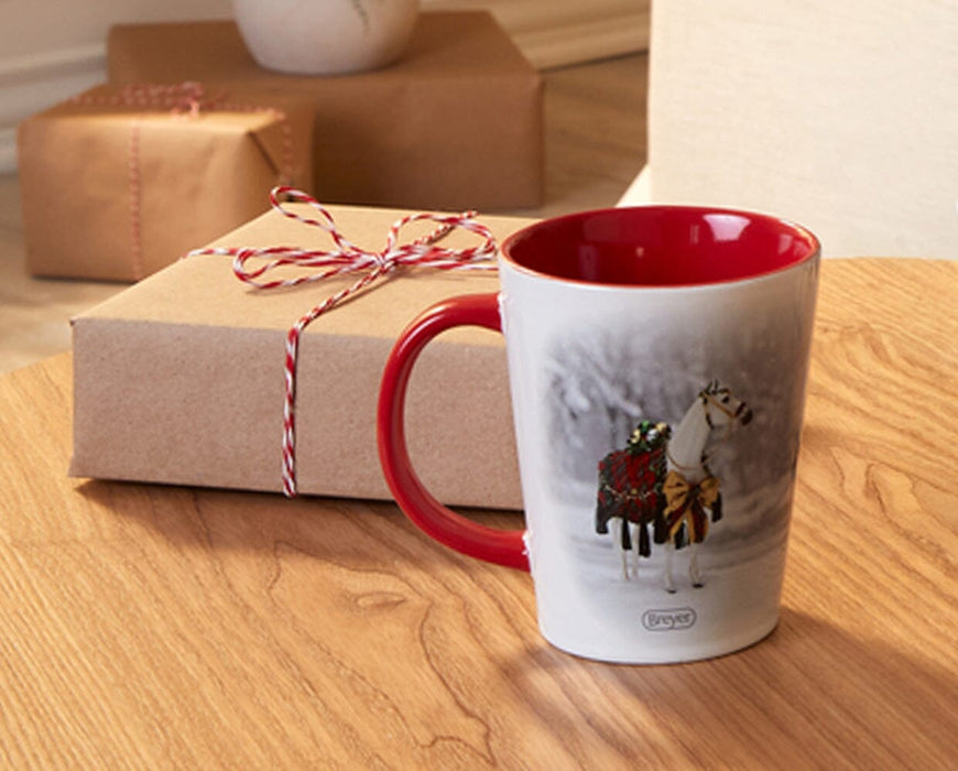 Holiday Homecoming Mug on a table with a holiday package