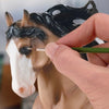 Painting eye of model horse