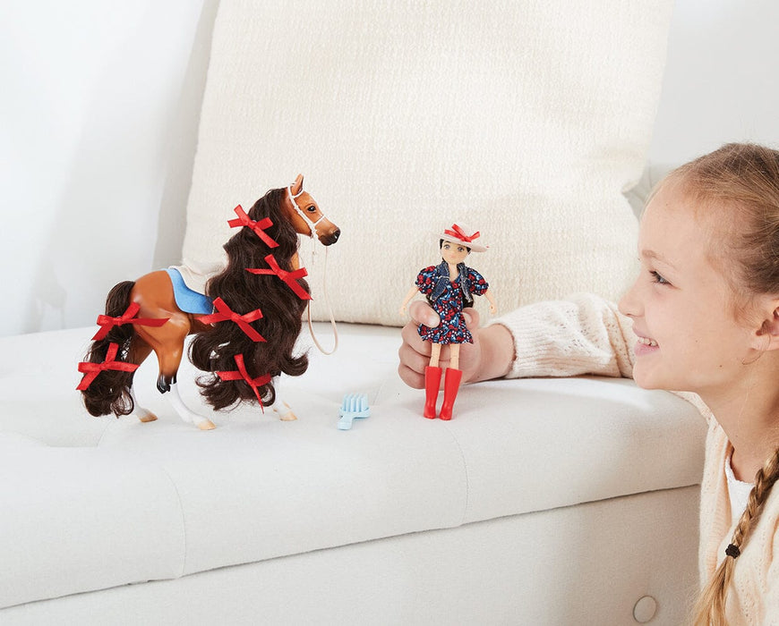 A child playing with Nora & Boots | Western Horse & Rider on a couch