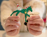 Someone holding up a finished Paint Your Own Horse | 2026 Ornament Craft Kit