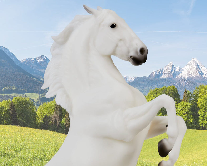 Pluto Gratia headshot rearing on a mountainous background facing right