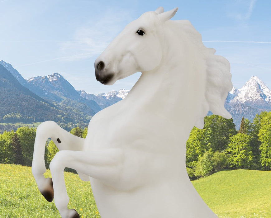 Pluto Gratia headshot rearing on a mountainous background facing left