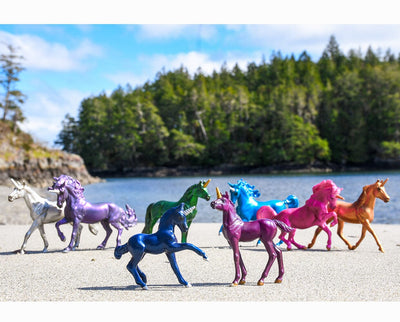 Sparkling Splendor Deluxe Unicorn Collection standing on the shore of a lake