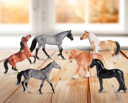 Stablemates Singles Six-Piece Assortment | Series 3 - models standing on a wooden table with a window in the background