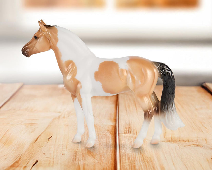 Stablemates Singles Six-Piece Assortment | Series 3 - Warmblood model standing on a wooden table with a window in the background