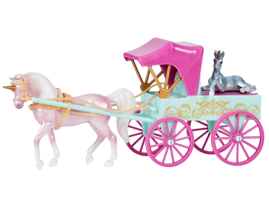 A side view of the Unicorn Magic Carriage & Foal Playset with the pink unicorn pulling it, with the foal in the carriage