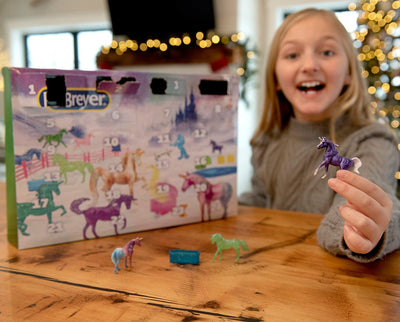 A girl playing with the Breyer Advent Calendar | Unicorn Magic