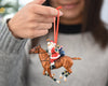 A child holding the Polo Playing Santa | Santa Ornament