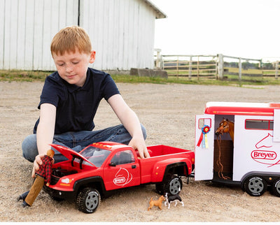 A boy with the Traditional Series "Dually" Truck and Trailer